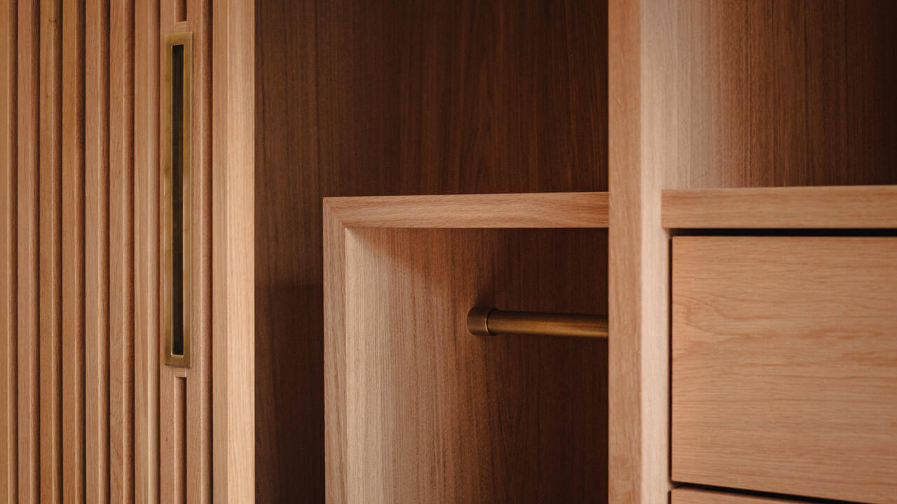 Custom Slatted Oak Wardrobe and Bespoke Joinery Details Modern bespoke hand selected and hand veneered slatted oak wardrobe with patinated brass details, crafted by Fundi Joinery Edinburgh