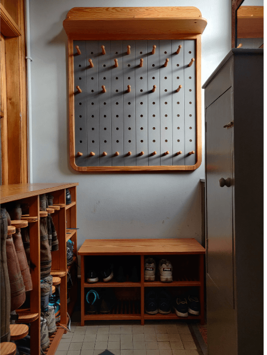 Bespoke Boot Room Furniture Bespoke boot room and storage rack with small seating and a peg board with pitch pine pegs for coats and scarf storage by Fundi Joinery in Edinburgh
