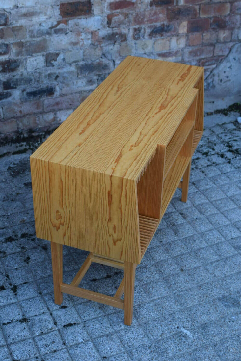 Book matched Pitch Pine following the contours of this handmade Credenza for turntables and vinyl records. Made by Fundi Joinery in Scotland