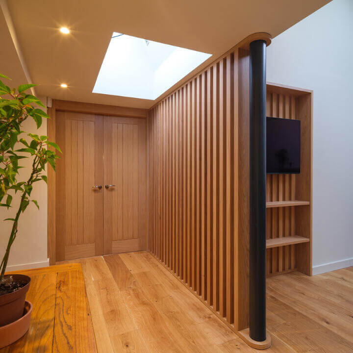 Modern Bespoke Oak Slat Feature Wall Bespoke handcrafted slatted privacy feature wall. Made from hand-selected European oak, showcasing large vertical oak slats. Made by Fundi Joinery in Edinburgh, Scotland