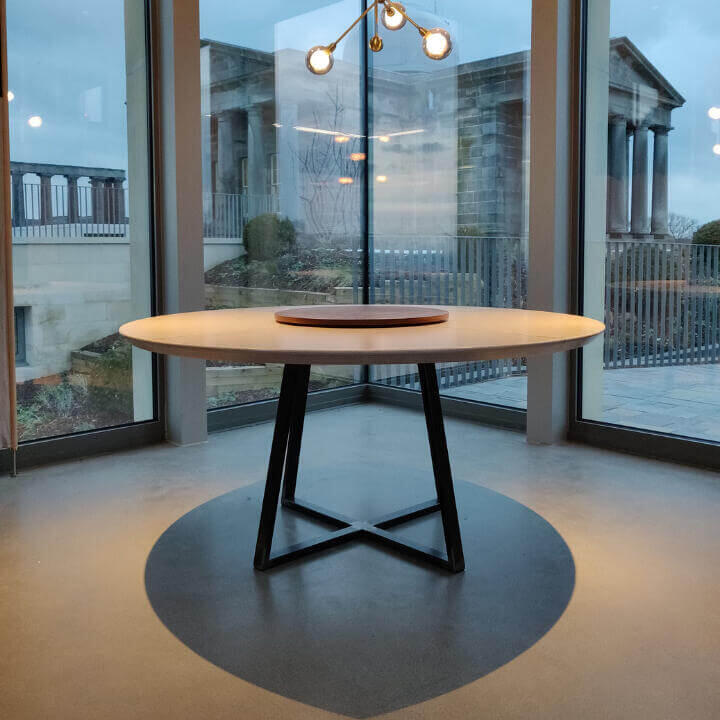 Bespoke modern round birch table top with brass inlay and a walnut lazy Susan. A bespoke raw steel geometric metal base, Made by Fundi Joinery in Edinburgh